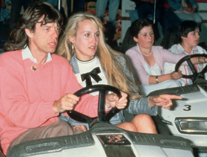 men bumper cars english group of people women recreation girl music mick jagger jerry hall festival american rock music couples caucasian ethnicity prominent persons rolling stones child driving boy person human kart transportation vehicle